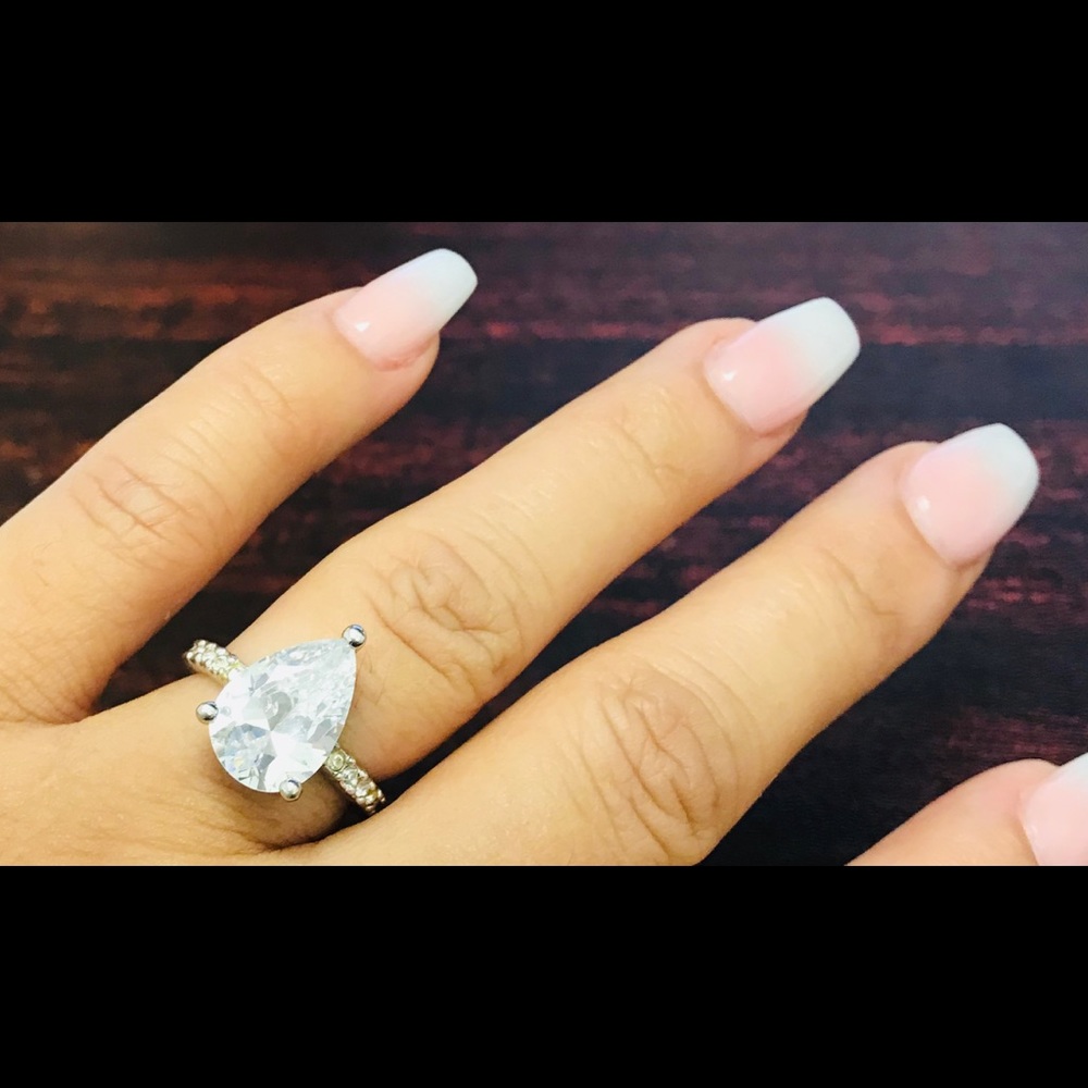 Silver teardrop ring.